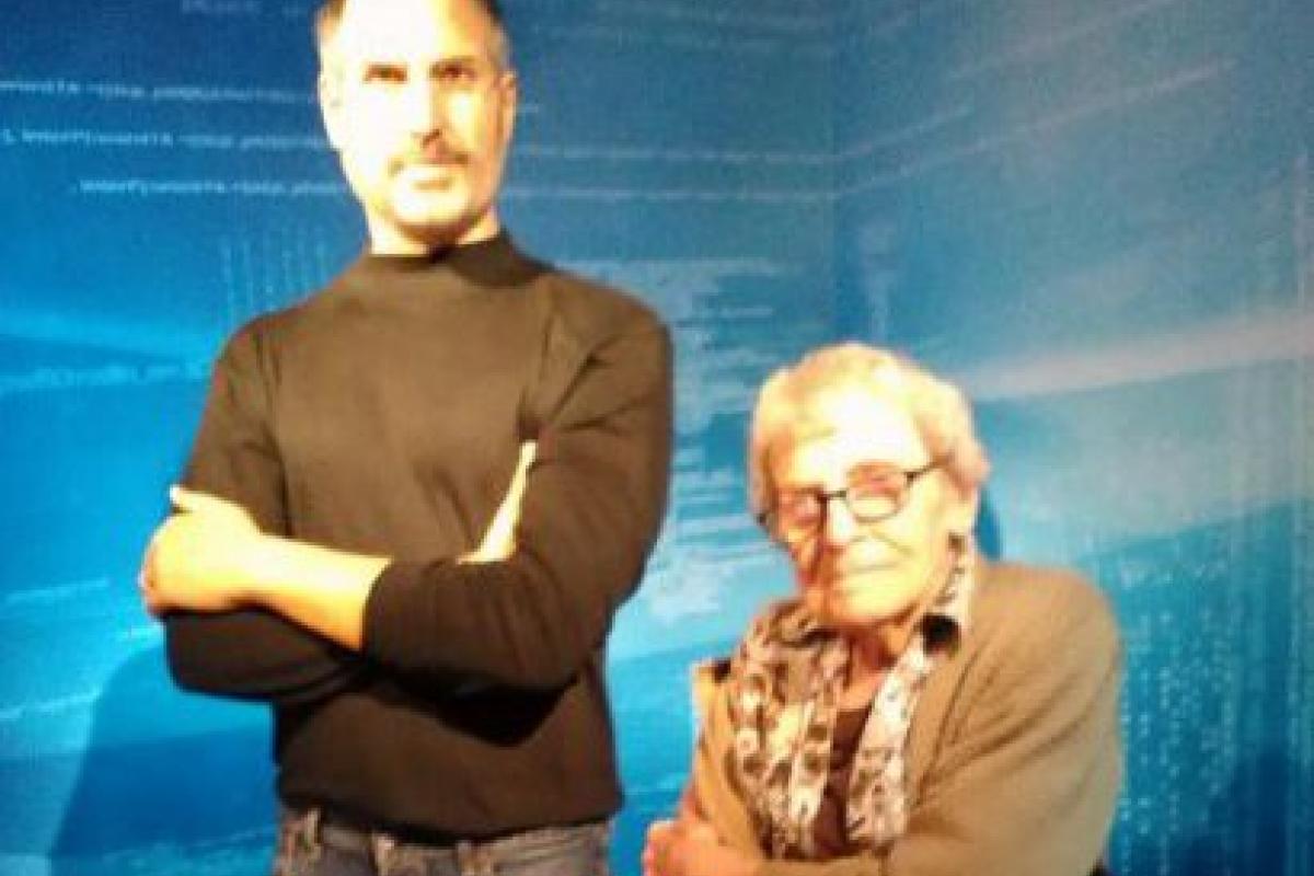 Woman Posing for Photo with Wax Figure of Steve Jobs