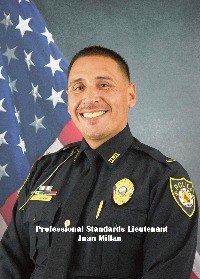 Headshot of Juan Millan in front of an American Flag.